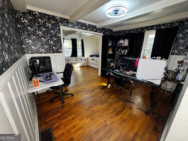 office space with visible vents, beamed ceiling, wainscoting, wood finished floors, and wallpapered walls