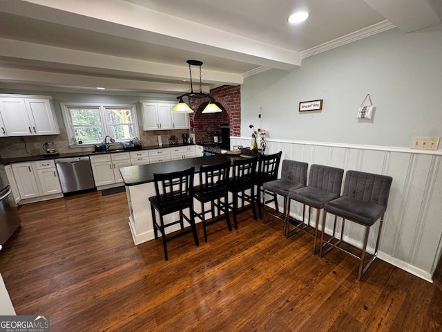 kitchen featuring dark wood-style floors, crown molding, dark countertops, dishwasher, and a sink