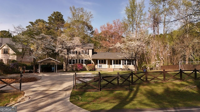 view of home's community with a carport, fence, a gate, and a lawn