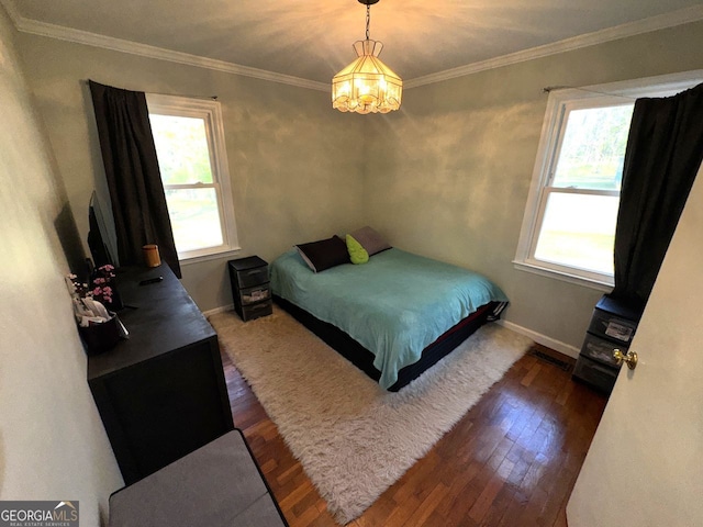 bedroom featuring a chandelier, multiple windows, dark wood finished floors, and baseboards