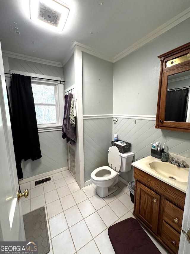 bathroom with ornamental molding, tile patterned floors, wainscoting, and visible vents