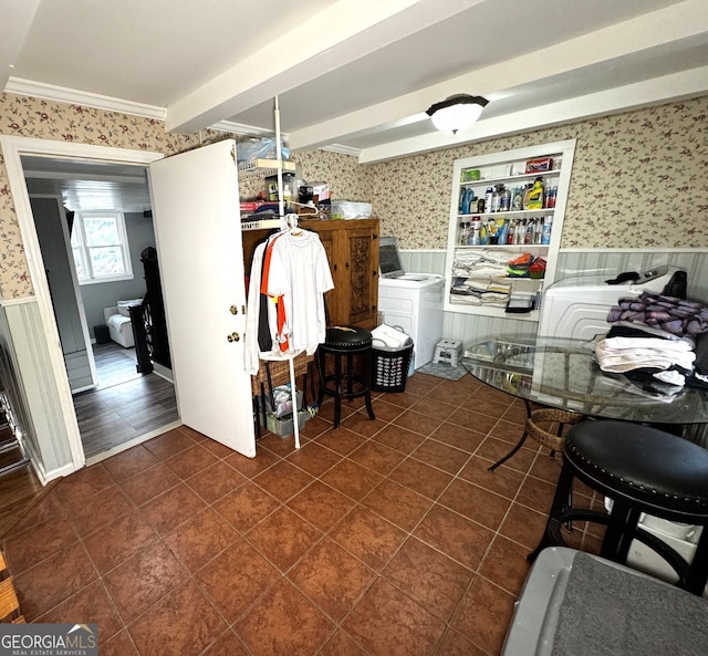 dining room with beamed ceiling, a wainscoted wall, dark tile patterned floors, wallpapered walls, and washing machine and dryer