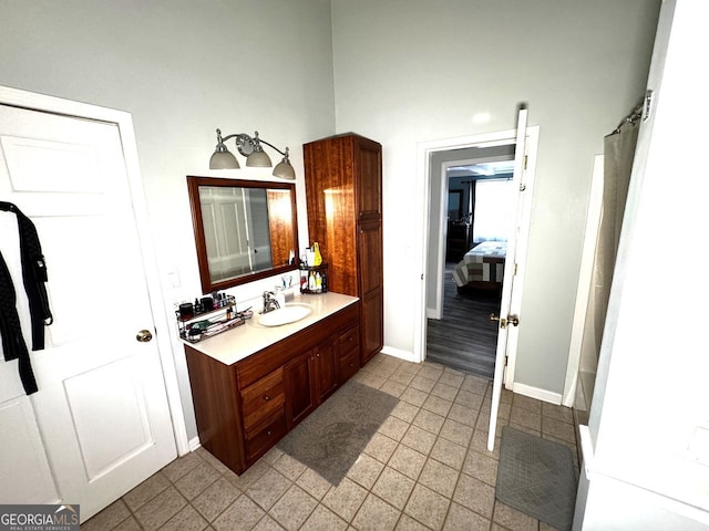 full bath featuring vanity and baseboards
