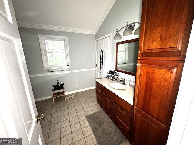 bathroom with ornamental molding, baseboards, vanity, and vaulted ceiling