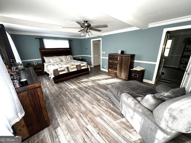 bedroom featuring crown molding, baseboards, ceiling fan, and wood finished floors