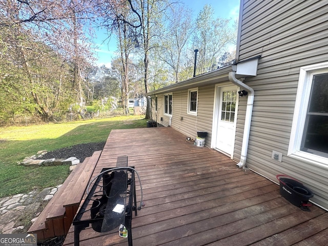 wooden terrace with a lawn