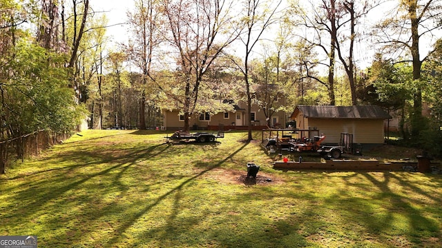 view of yard with an outdoor structure and fence