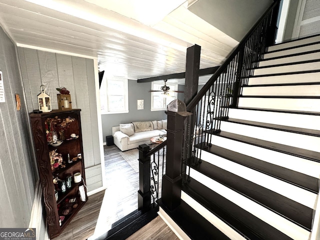 stairway with wood ceiling, wood finished floors, and ceiling fan