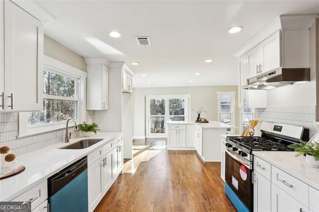 645 Trailmore Pl, Roswell, GA 30076 - kitchen featuring stainless steel range with gas cooktop, dishwasher, under cabinet range hood, backsplash, and healthy amount of natural light