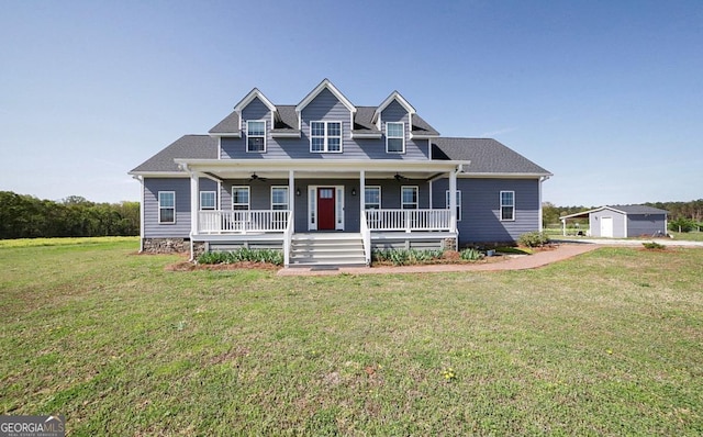 2587 Moons Grove Church Rd, Colbert, GA 30628 - new england style home featuring a porch, ceiling fan, a front yard, and an outbuilding