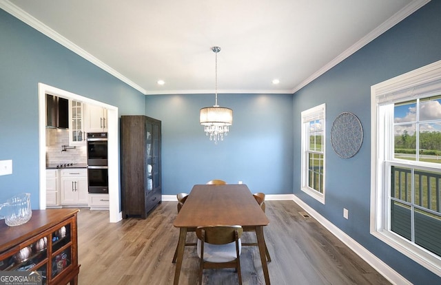 2587 Moons Grove Church Rd, Colbert, GA 30628 - dining area with wood finished floors, a chandelier, crown molding, and recessed lighting