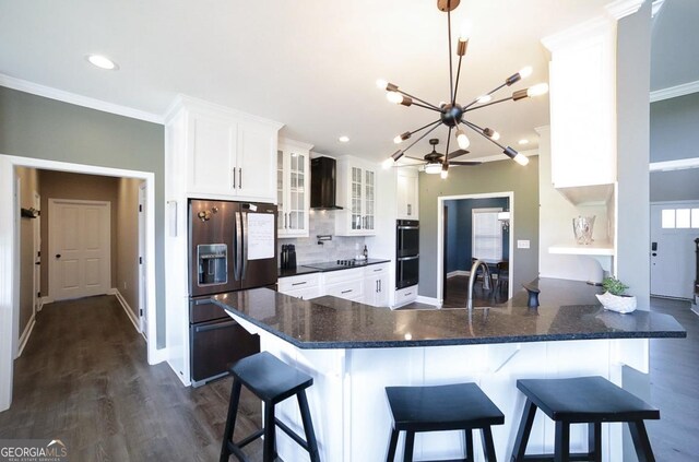 2587 Moons Grove Church Rd, Colbert, GA 30628 - kitchen with black appliances, a chandelier, ornamental molding, wall chimney range hood, and white cabinetry