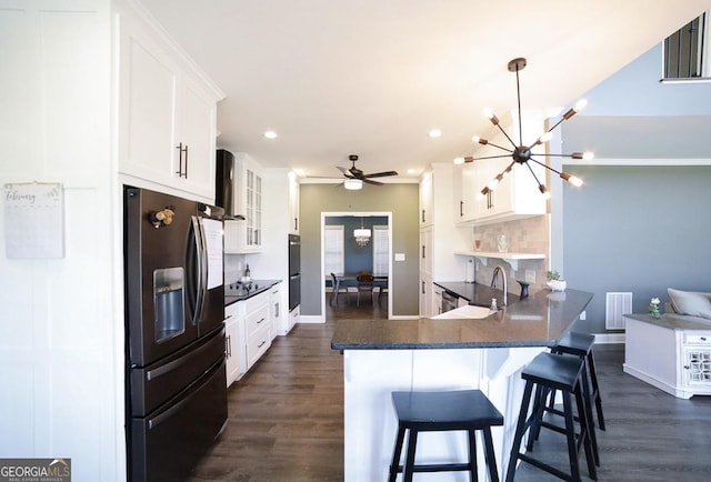 2587 Moons Grove Church Rd, Colbert, GA 30628 - kitchen with stainless steel refrigerator with ice dispenser, a chandelier, dark wood-style floors, black electric cooktop, and recessed lighting