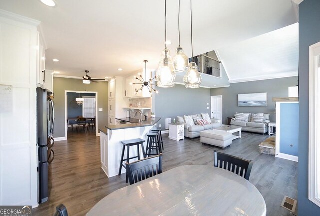 2587 Moons Grove Church Rd, Colbert, GA 30628 - dining room featuring crown molding, a chandelier, a ceiling fan, recessed lighting, and dark wood-style flooring