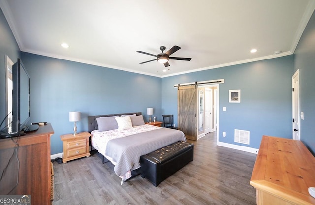 2587 Moons Grove Church Rd, Colbert, GA 30628 - bedroom featuring a barn door, wood finished floors, recessed lighting, crown molding, and a ceiling fan