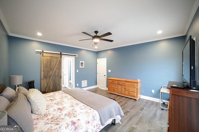 2587 Moons Grove Church Rd, Colbert, GA 30628 - bedroom featuring wood finished floors, recessed lighting, a barn door, a ceiling fan, and crown molding