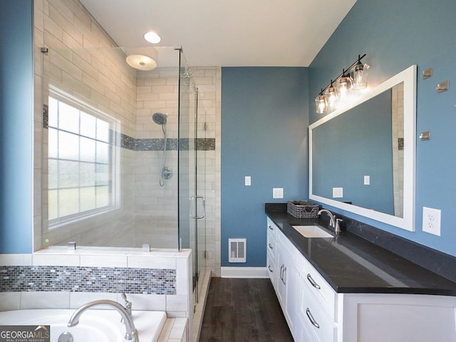 2587 Moons Grove Church Rd, Colbert, GA 30628 - full bathroom featuring a stall shower, vanity, a bath, and wood finished floors