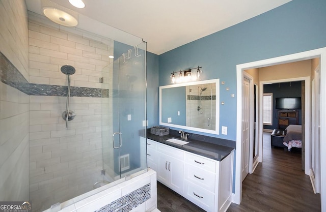 2587 Moons Grove Church Rd, Colbert, GA 30628 - ensuite bathroom with a stall shower, wood finished floors, and vanity