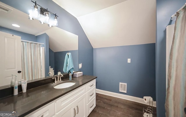 2587 Moons Grove Church Rd, Colbert, GA 30628 - full bath with vanity, wood finished floors, and lofted ceiling