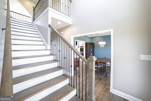 2587 Moons Grove Church Rd, Colbert, GA 30628 - staircase featuring wood finished floors and a high ceiling