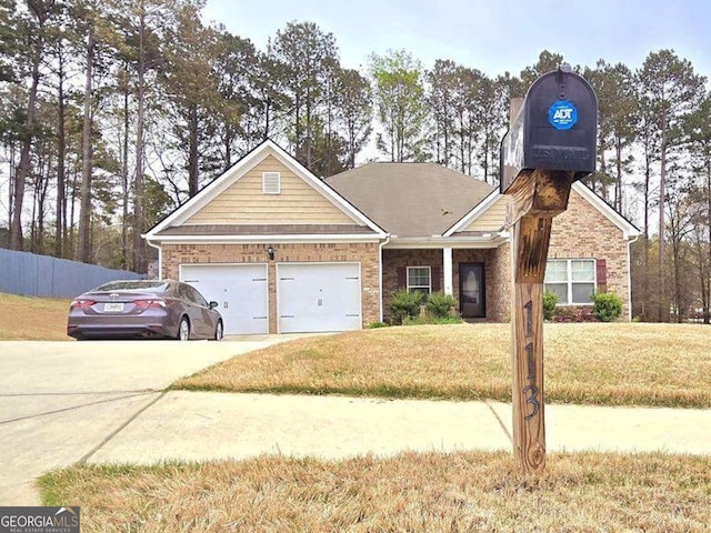 113 Citadel Dr, Hampton, GA 30228 - view of front of home featuring concrete driveway, a front lawn, an attached garage, and brick siding