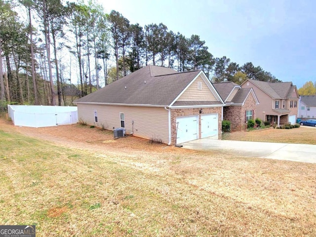 113 Citadel Dr, Hampton, GA 30228 - view of home's exterior with concrete driveway, a garage, and brick siding