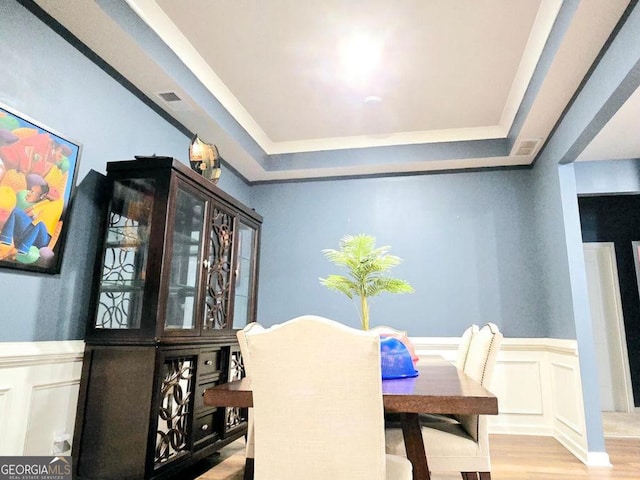 113 Citadel Dr, Hampton, GA 30228 - dining room with a raised ceiling, wainscoting, wood finished floors, and a decorative wall