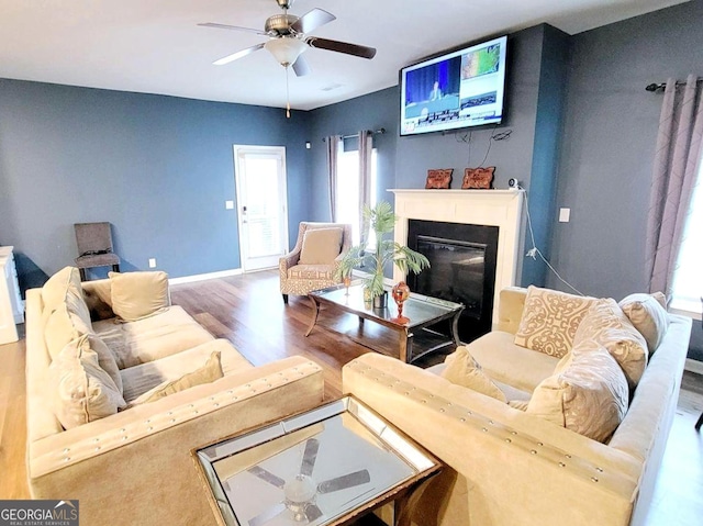113 Citadel Dr, Hampton, GA 30228 - living room with wood finished floors, a glass covered fireplace, and a ceiling fan