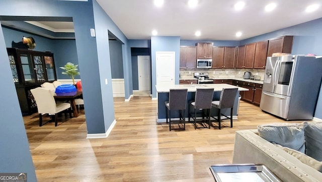 113 Citadel Dr, Hampton, GA 30228 - kitchen with appliances with stainless steel finishes, light countertops, a breakfast bar area, light wood finished floors, and recessed lighting