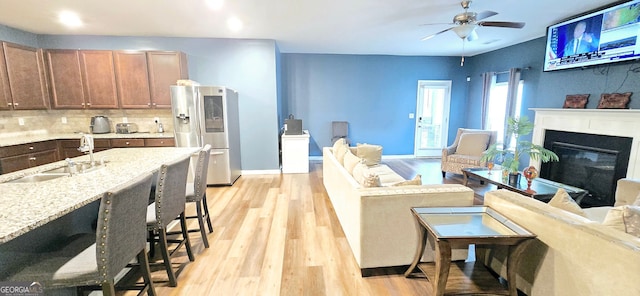 113 Citadel Dr, Hampton, GA 30228 - living room with ceiling fan, light wood-type flooring, a glass covered fireplace, and recessed lighting