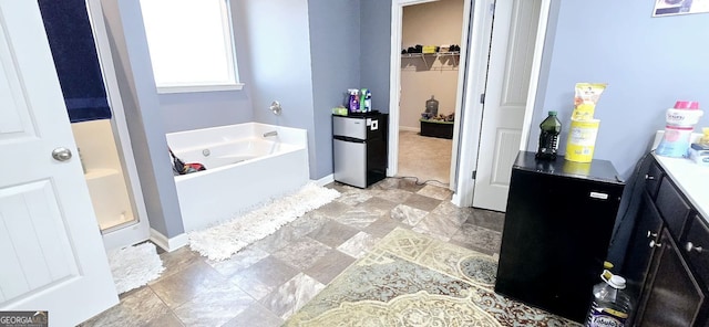 113 Citadel Dr, Hampton, GA 30228 - bathroom with stone finish floors, a bath, a spacious closet, and a shower
