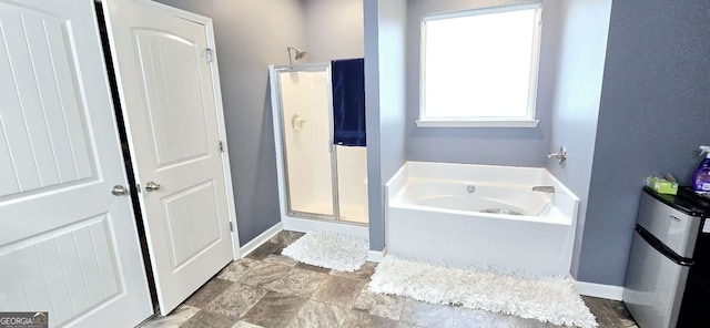 113 Citadel Dr, Hampton, GA 30228 - full bathroom featuring a bath, a stall shower, and stone finish flooring