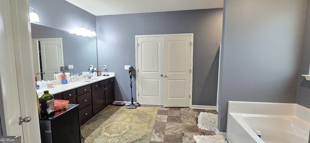 113 Citadel Dr, Hampton, GA 30228 - full bathroom with a garden tub, vanity, and stone finish floors