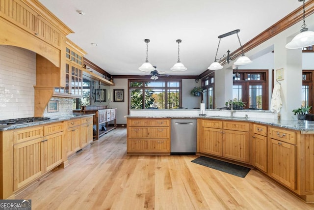 kitchen with stainless steel dishwasher, ornamental molding, decorative backsplash, light wood-style floors, and gas stovetop