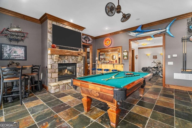 playroom with stone tile flooring, ornamental molding, a fireplace, billiards, and baseboards