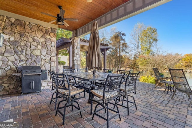 view of patio featuring ceiling fan, outdoor dining space, and area for grilling