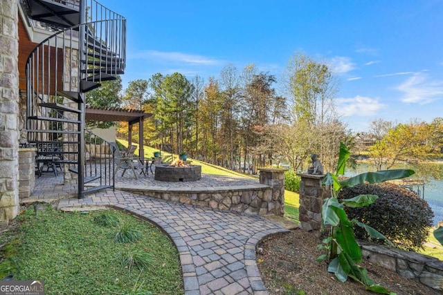 view of yard with stairway, an outdoor fire pit, and a patio area