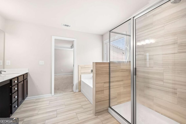 full bathroom with a stall shower, vanity, a bath, baseboards, and visible vents