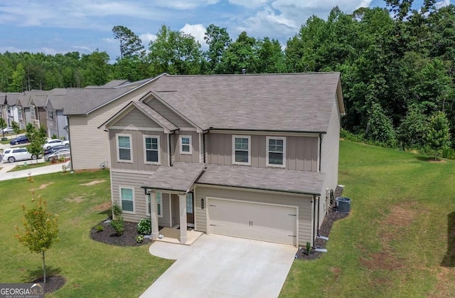 view of front of house featuring an attached garage, central AC, concrete driveway, a front yard, and board and batten siding