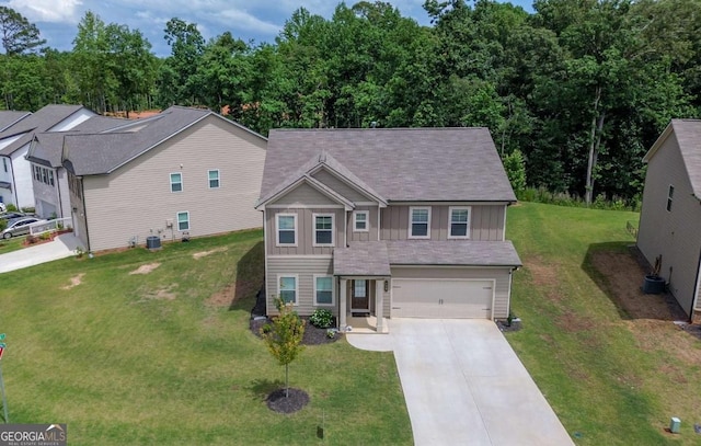 view of front of property featuring concrete driveway, an attached garage, board and batten siding, a front lawn, and central AC
