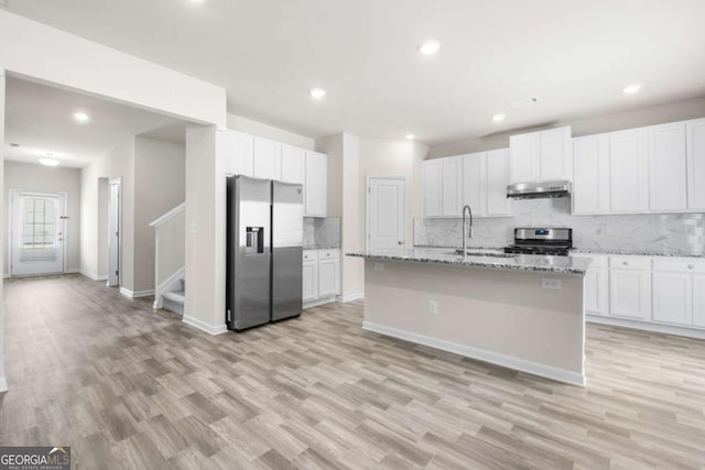 kitchen with white cabinetry, a sink, appliances with stainless steel finishes, and under cabinet range hood