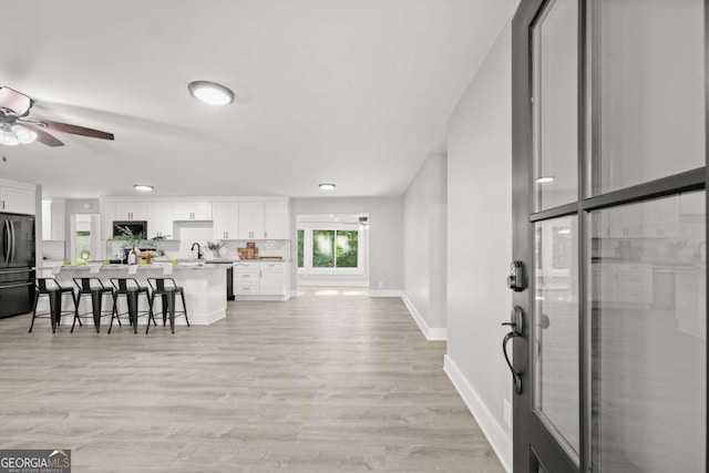 5198 Holly Springs Rd, Pendergrass, GA 30567 - interior space featuring a ceiling fan, light countertops, a breakfast bar, freestanding refrigerator, and white cabinets