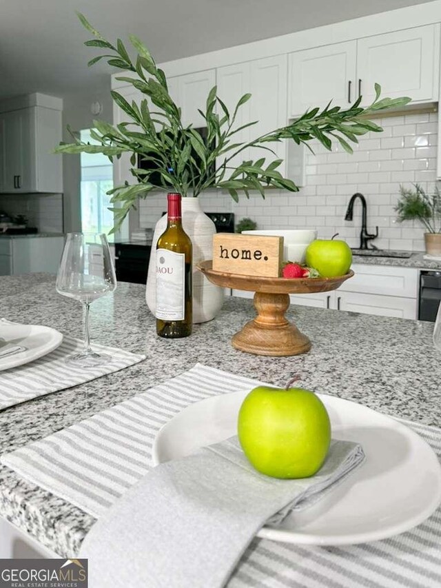 5198 Holly Springs Rd, Pendergrass, GA 30567 - details featuring white cabinets, backsplash, and light stone counters