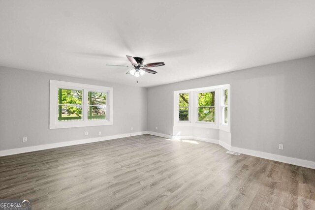 5198 Holly Springs Rd, Pendergrass, GA 30567 - empty room with baseboards, visible vents, wood finished floors, and ceiling fan