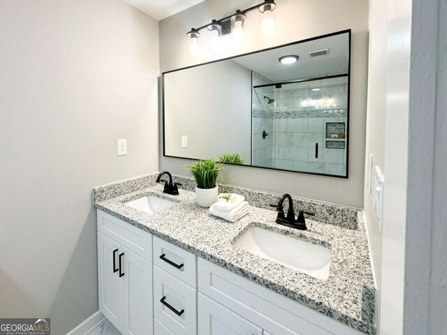 5198 Holly Springs Rd, Pendergrass, GA 30567 - bathroom featuring baseboards, double vanity, a sink, and a stall shower