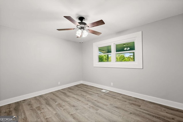 5198 Holly Springs Rd, Pendergrass, GA 30567 - spare room featuring baseboards, visible vents, wood finished floors, and a ceiling fan