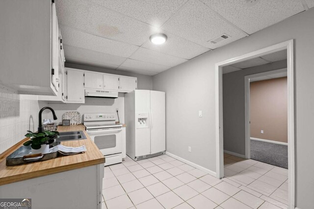 5198 Holly Springs Rd, Pendergrass, GA 30567 - kitchen featuring visible vents, white appliances, under cabinet range hood, white cabinetry, and a sink