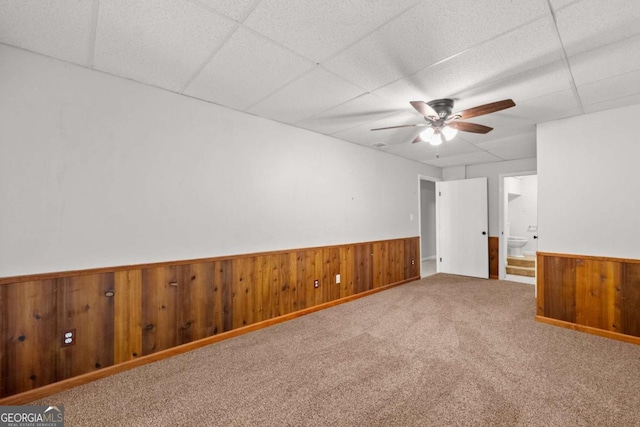 5198 Holly Springs Rd, Pendergrass, GA 30567 - unfurnished room featuring carpet flooring, a ceiling fan, wood walls, wainscoting, and a paneled ceiling