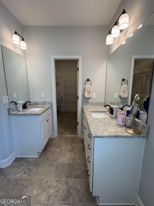 4529 Jersey Covington Rd, Covington, GA 30014 - full bath featuring two vanities, a spacious closet, and baseboards
