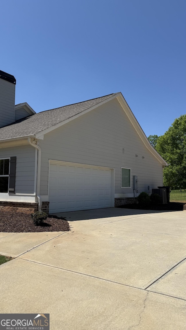 4529 Jersey Covington Rd, Covington, GA 30014 - view of property exterior with concrete driveway, an attached garage, and a shingled roof